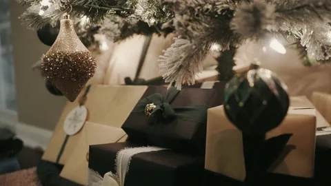 Focus pull from ornaments on a Christmas tree to the presents underneath Stock Footage 226143498