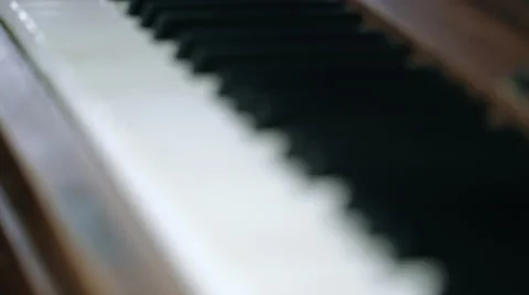 Focus pull over black and white keys of vintage old piano Stock Footage 65381172