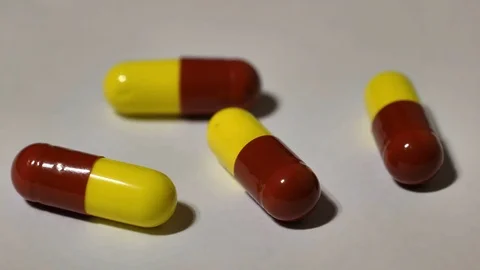 Focus pull on pills red and yellow Stock Footage 81992547