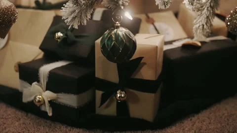 Focus pull from presents underneath a Christmas tree to a single ornament Stock Footage 226146540