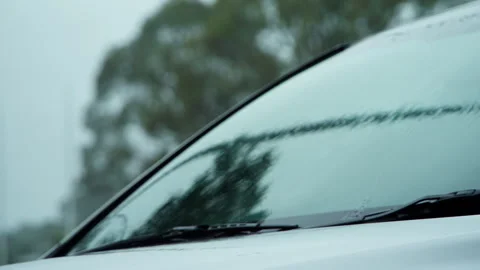 Focus Pull From Rain on Windshield to Autumn Leaves in Background Stock Footage 330727292