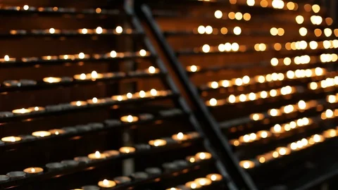 Focus pull. Rows of hundreds isolated burning candles on background Stock Footage 123667925