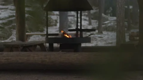 Focus pull shot of fire burning in outdoor fireplace in wintery setting Stock Footage 146267285