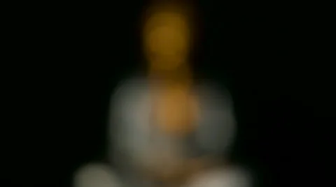 Focus pull on silver and golden seating Buddha statue Stock Footage 65524249