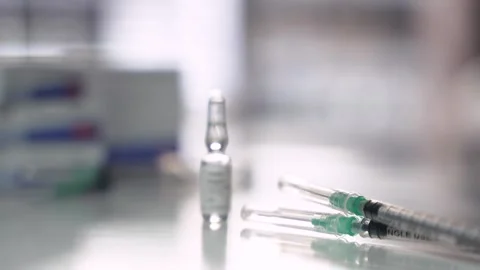 Focus Pull from Syringes to Testosterone Ampoule Stock Footage 325164915