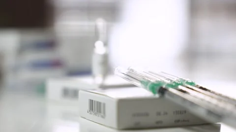 Focus Pull from Syringes to Testosterone Ampoule Stock Footage 327477405