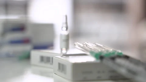 Focus Pull from Syringes to Testosterone Ampoule Stock Footage 327477894