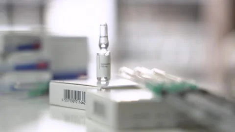 Focus Pull from Testosterone Ampoule to Syringes Stock Footage 327478567