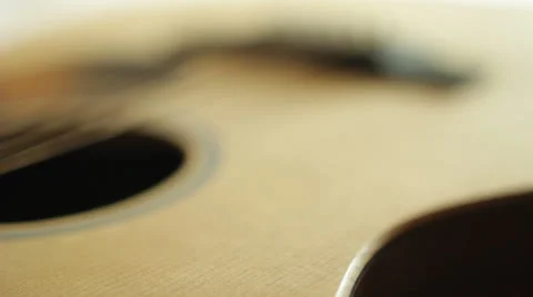 Focus Pull through base of guitar Stock Footage 38550784