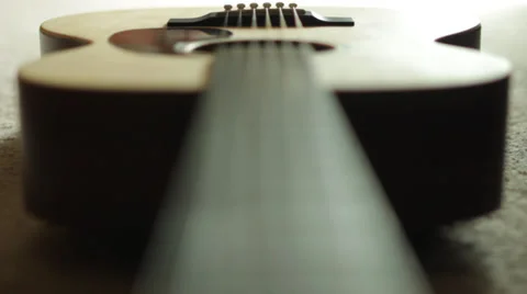 Focus pull through guitar strings Stock Footage 38550760