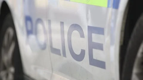 Focus pull through police sign on police car, UK Vídeos de archivo 69071327