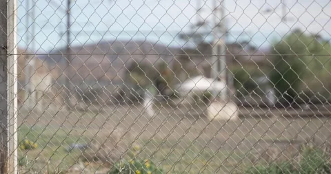 Focus pull from wire fence to train tracks Stock Footage 277386223
