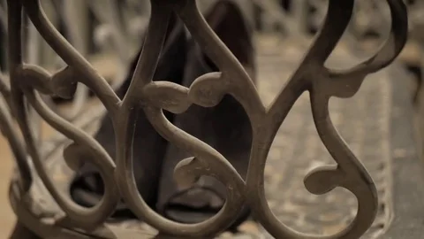 Focus Pulling on Black High Heels through Wrought Iron Bench at Night Stock Footage 73943653