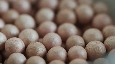 Focus pulling on blush balls in a box 4K video Stock Footage 169809616