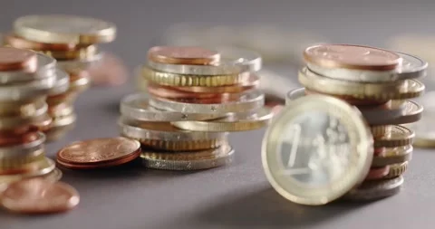 Focus pulling from Coins in background to 1 Euro coin in the foreground. Stock Footage 147937697
