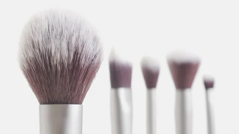 Focus pulling on hairy make-up brushes 4K video Stock Footage 145440746