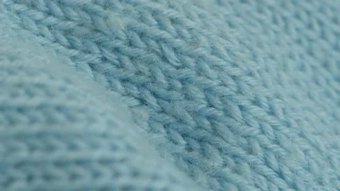 Focus pulling over knitted blue yarn 4K video Stock Footage 194668317