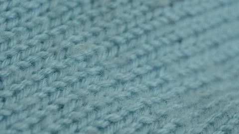 Focus pulling over knitted kids jumper 4K video Stock Footage 193481434