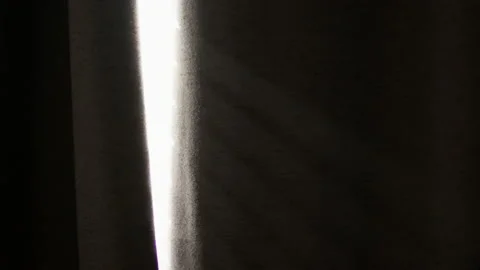 Focus Rack To Sun Shining Through Black Curtains 4K Stock Footage 170920925