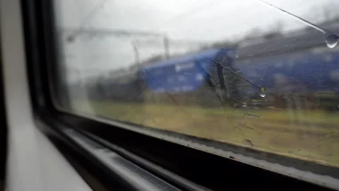 Focus on raindrops on window of compartment in a train carriage Stock Footage 272293306