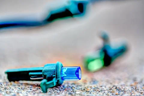 Focus on replacement bulb for a string of Christmas lights to repair a dud. Stock Photos