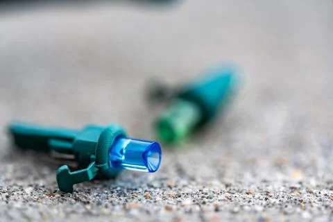 Focus on replacement bulb for a string of Christmas lights to repair a dud. Stock Photos