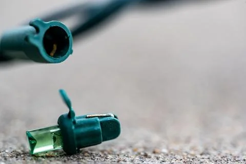 Focus on replacement bulb for a string of Christmas lights to repair a dud. Stock Photos