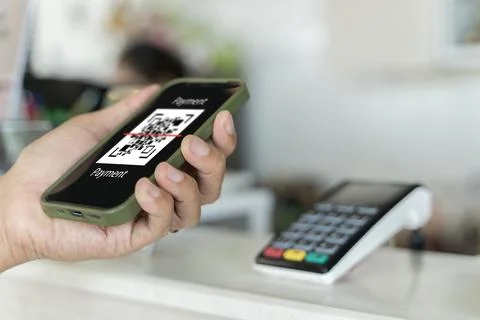 Focus on Scan here to pay text, Close up of hands Scaning QR code for digit.. Foto stock