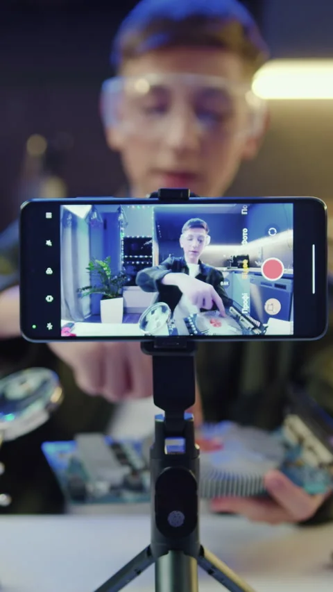 Focus on screen of smartphone. Young man is live streaming a training blog  Stock Footage 327371788