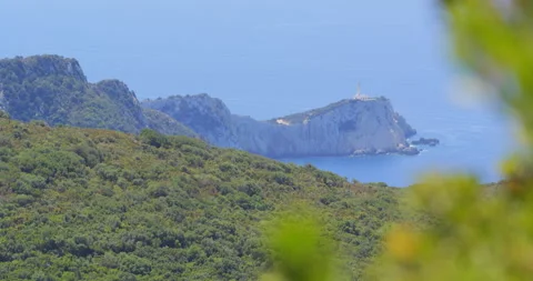 Focus shift on Cape Doukato with its lighthouse far away Stock Footage 298933374