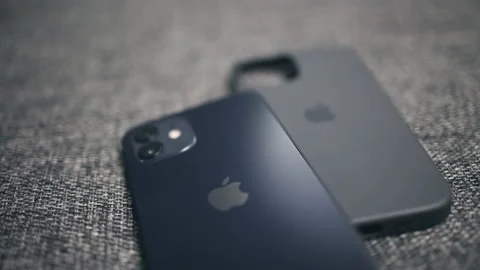 Focus shift close-up of back of new iPhone and phone case, Apple logo Stock Footage 149452167
