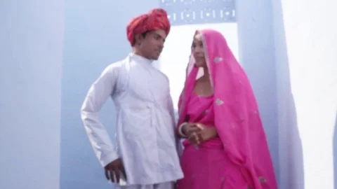 Focus shift to a gorgeous traditional bride and groom in traditional wear agains Stock Footage 70340445
