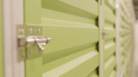 Focus Shift Revealing Latch on Green Self Storage Door Stock Footage 321985369