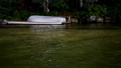 A focus shift of a water to a small metal boat. Stock Footage 96540809