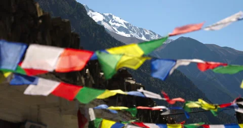 Focus shot of Buddhist flags flutter with mountain peeking in Annapurna Stock Footage 344690475