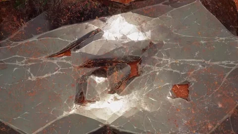 A focus shot of a cracked reflective crystal like surface with intricate Stock Footage 317869324