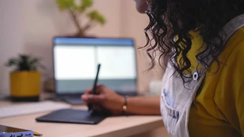 Focus shot on face and hands of an African American woman working with drawing Stock Footage 238023348