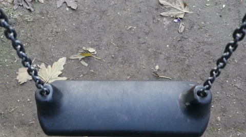 Focus on single swinging swing Stock Footage 63418752