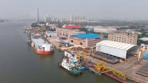 The focus is on a small cargo dock with moored tugboats and cargo ships. Video stock 118028735