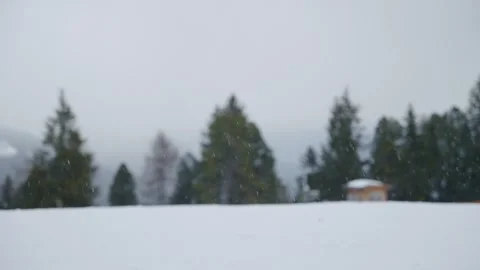 Focus on snowflakes snowing down from sky during winter vacation in ski resort Stock Footage 261763397