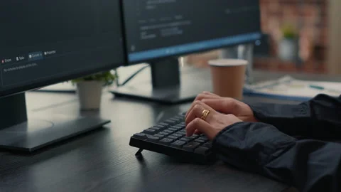 Focus on software developer hands typing source code on keyboard while looking Stock Footage 168231733
