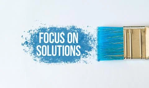 Focus on Solution text on blue paint with brush on white background Stock Photos