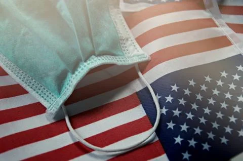 Focus on some points of Surgery mask on United State flag Background. Stock Photos