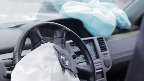 Focus on the steering wheel of the car and the deployed airbag Stock Footage 204872602