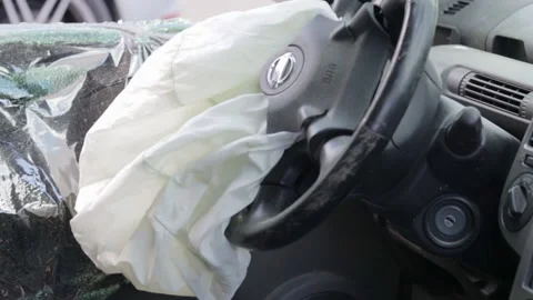 Focus on the steering wheel of the car and the deployed airbag Stock Footage 204872606