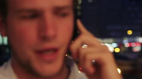Focus switches from background to face of man on the phone Stock Footage 40698812