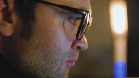 Focus on the task in dim light setting with intense concentration Stock Footage 305151826