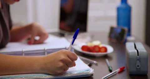 Focus on the task at hand: A person is engrossed in writing. Stock Footage 334776449