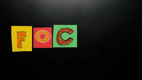 Focus through creative hands as fingers place colorful letters one by one to Stock Footage 324812940