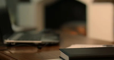 Focus through the desktop on an artificial fireplace Stock Footage 87324506